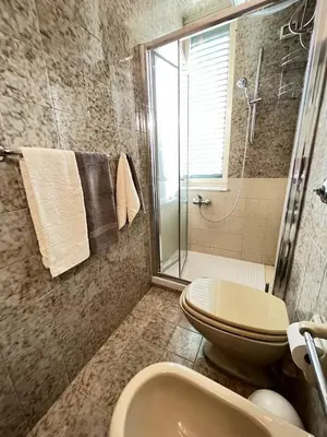 a bathroom with a shower and a toilet and a sink at Sunny Home in Palermo