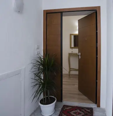 a door leading into a room with a potted plant at Terre d'oro, appartamento di lusso in centro città in Palermo