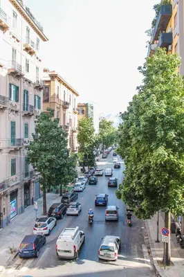 a busy city street filled with cars and buildings at Alexander House in Palermo
