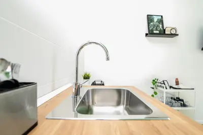 a stainless steel sink in a kitchen at Valguarnera Studio Apartments in Palermo