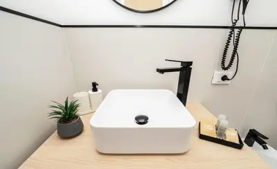a bathroom with a white sink and a mirror at Valguarnera Studio Apartments in Palermo
