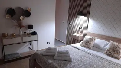 a bedroom with a bed with towels on it at Garden Suite Apartment in Palermo