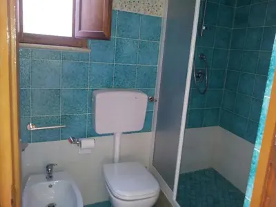 a small bathroom with a toilet and a sink at Casa Vacanza Terrazza sul Mare in Castellammare del Golfo