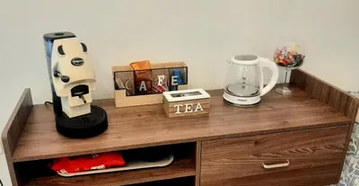 a wooden table with a blender and other items on it at La casetta degli ulivi in Palermo