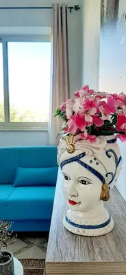 a large vase with flowers on top at La casetta degli ulivi in Palermo