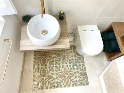 a bathroom with a white sink and a toilet at Casa 900 in Castellammare del Golfo
