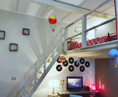 a living room with a staircase with a bunk bed at Ally's house in Palermo