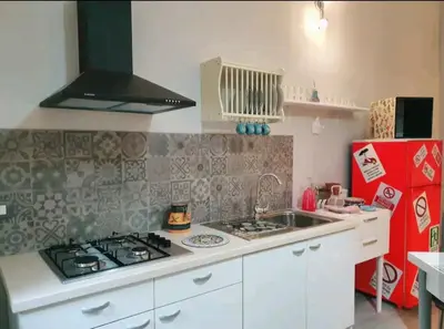 a small kitchen with a stove and a sink at Ally's house in Palermo