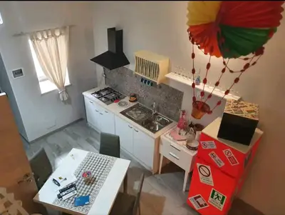 an overhead view of a kitchen with a table and a stove at Ally's house in Palermo