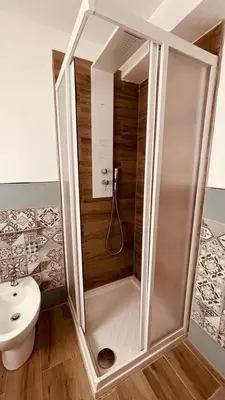 a shower in a bathroom with a toilet and a sink at L'angolo in centro in Partinico