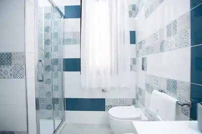 a blue and white bathroom with a toilet and a shower at La Chiostrina in Castellammare del Golfo