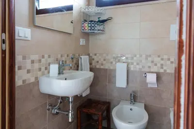 a bathroom with a sink and a toilet at Al ficodindia in Scopello