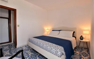 a bedroom with a bed with a blue and white floor at Amazing Home In Trappeto With Wifi in Trappeto