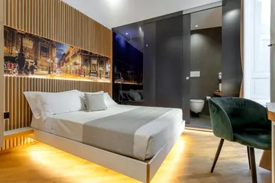 a bedroom with a bed and a desk and a chair at Hibrido in Palermo