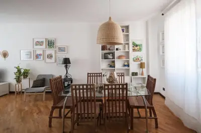 a dining room with a glass table and chairs at Casa Sul Mare Seaside apt in front of the sea in Palermo