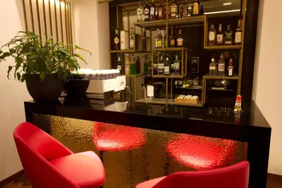 a bar with a red chair and a red bar stool at Palazzo Cartari in Palermo