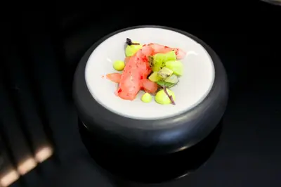 a plate of food with fruit on a table at Palazzo Cartari in Palermo