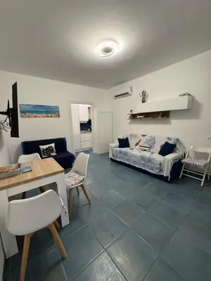 a living room with a couch and a table at Casa Vacanze Marinella Beach in San Vito lo Capo