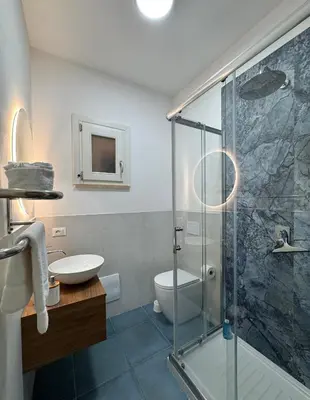 a bathroom with a shower and a toilet and a sink at Casa Vacanze Marinella Beach in San Vito lo Capo