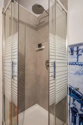 a shower with a glass door in a bathroom at Aurora Apartment by Domus Sicily in Palermo