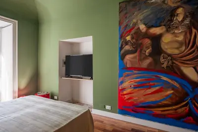a painting on the wall of a bedroom at Aurora Apartment by Domus Sicily in Palermo