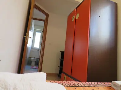 a red cabinet in a room with a mirror at Awesome terrace and apartment in the city centre in Palermo
