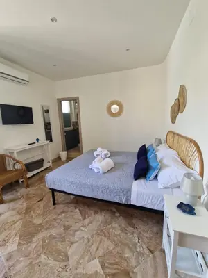 a bedroom with a bed with two stuffed animals on it at Posidonia B&B in Terrasini
