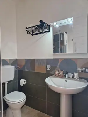 a bathroom with a sink and a toilet and a mirror at Posidonia B&B in Terrasini