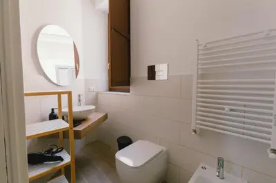 a bathroom with a toilet and a sink at Ballaro' House in Palermo
