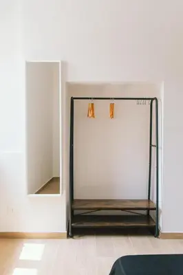 a dressing room with a mirror and a bed at Ballaro' House in Palermo