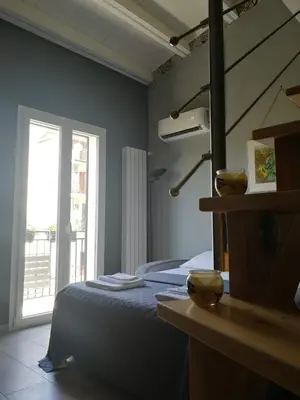 a bedroom with a bed and a large window at Casa da Giannina in Palermo