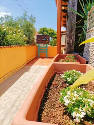 a garden with flowers in a planter on a balcony at Villemar in Isola delle Femmine