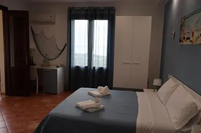 a bedroom with a bed with two towels on it at Verdemare in Macari