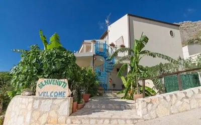 a house with a sign in front of it at Verdemare in Macari