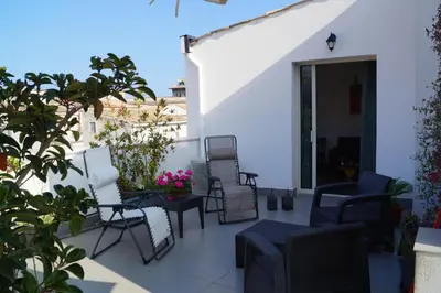 a group of chairs and tables on a patio at Guascone Apartments in Palermo