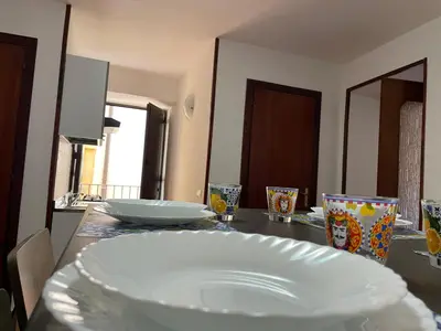 a table with a white plate on top of it at DM house in Palermo