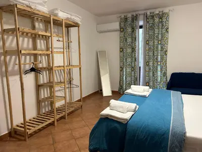a room with a bed and a book shelf at DM house in Palermo