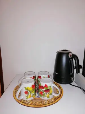 a tray with three tea cups and a tea kettle at DM house in Palermo