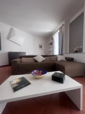 a living room with a couch and a table at Terrazza Rosa Bianca in Palermo