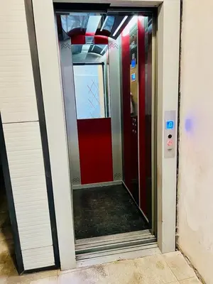 an empty corridor with a red door in a building at Terrazza Rosa Bianca in Palermo