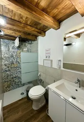 a bathroom with a toilet and a sink at Mafone Home in Palermo