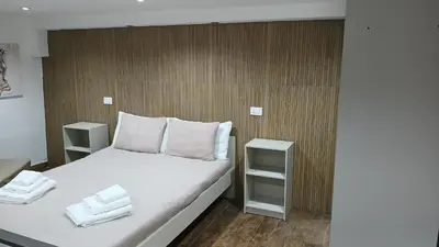 a bedroom with a bed with two white towels on it at Mafone Home in Palermo