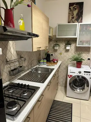 a kitchen with a sink and a stove top oven at A Casuzza di Gio in Palermo