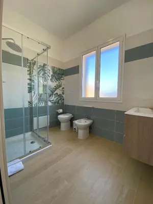 a bathroom with a shower and a toilet and a sink at B&B Le Venere Rooms in Castellammare del Golfo