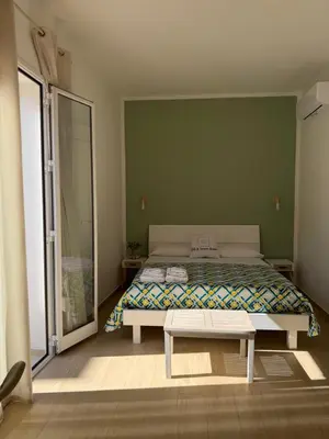 a bedroom with a bed and a bench in it at B&B Le Venere Rooms in Castellammare del Golfo