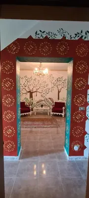a living room with a red wall with a chandelier at I Sollazzi in Palermo