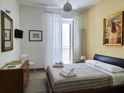 a bedroom with a bed with two towels on it at Appartamento Salinas Palermo in Palermo