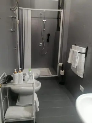 a bathroom with a shower and a toilet and a sink at Historic Centre - Apartment at Foro Borbonico in Palermo