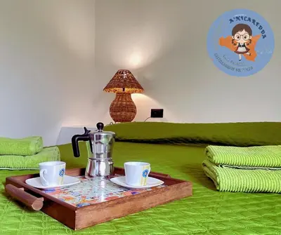 a living room with a coffee table with two cups and a coffee pot at A'nicaredda (la piccolina) in Castellammare del Golfo