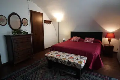 a bedroom with a bed and a dresser and a mirror at Room in Villa Galletti Inguaggiato in Bagheria